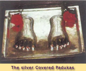 THE SILVER COVERED PADUKAS IN FRONT OF BABA'S PORTRAIT
